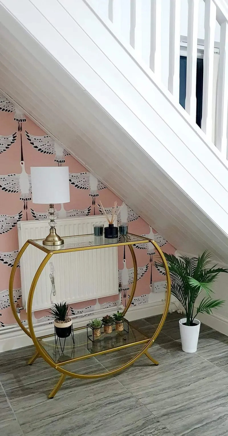 Boutique attic space finished in soft pink with feature lighting