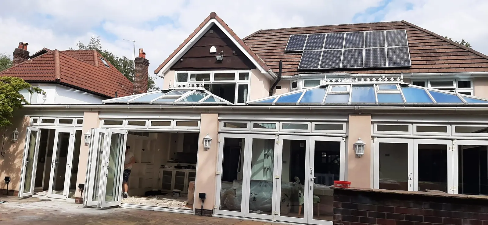Rear elevation repainted in white render around bifold doors
