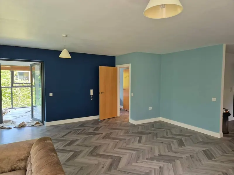 Living room repainted in navy and duck egg over herringbone flooring
