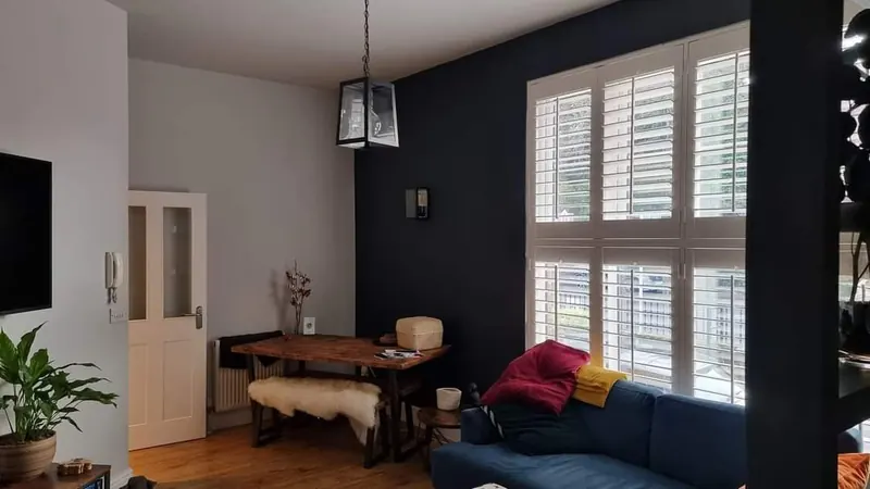 Lounge in soft grey with plantation shutters